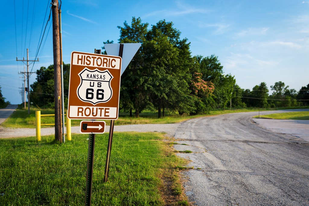 Historic Route 66 road sign in a stretch of the original road in Kansas.